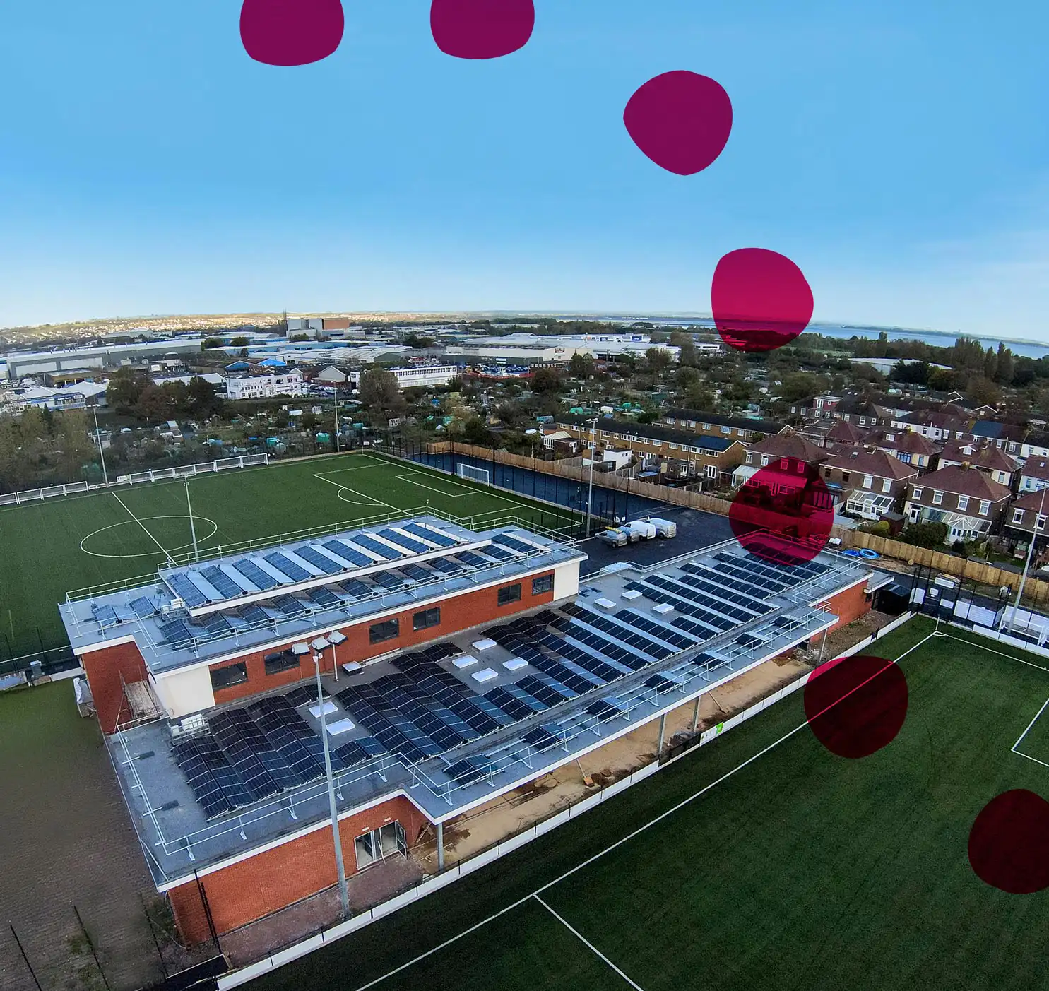 Aerial shot of Pompey in the Community's sports stadium with solar panels installed, highlighting clean energy solutions.