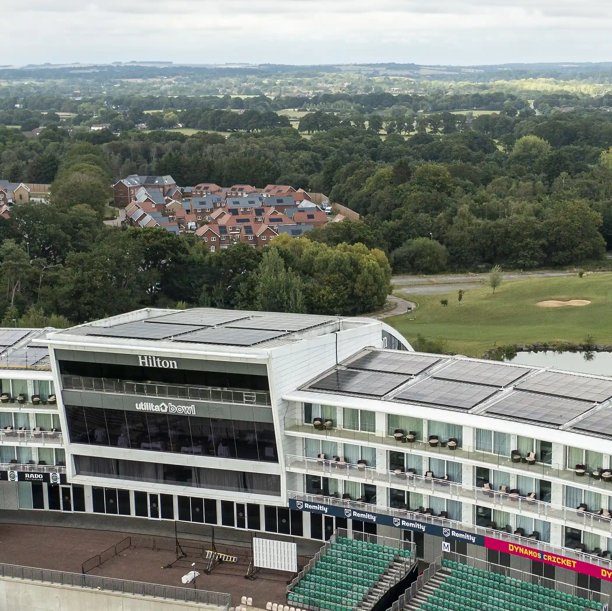 Aerial view of the Hilton Southampton hotel with rooftop solar panels, showing solar energy benefits for hospitality venues.