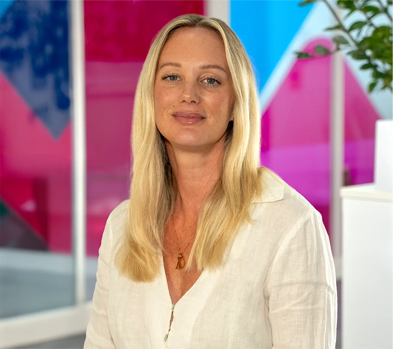 Photo of Felicity Neaves, Head of Commercial at Utilita Business, sat in front of colourful glass panels.