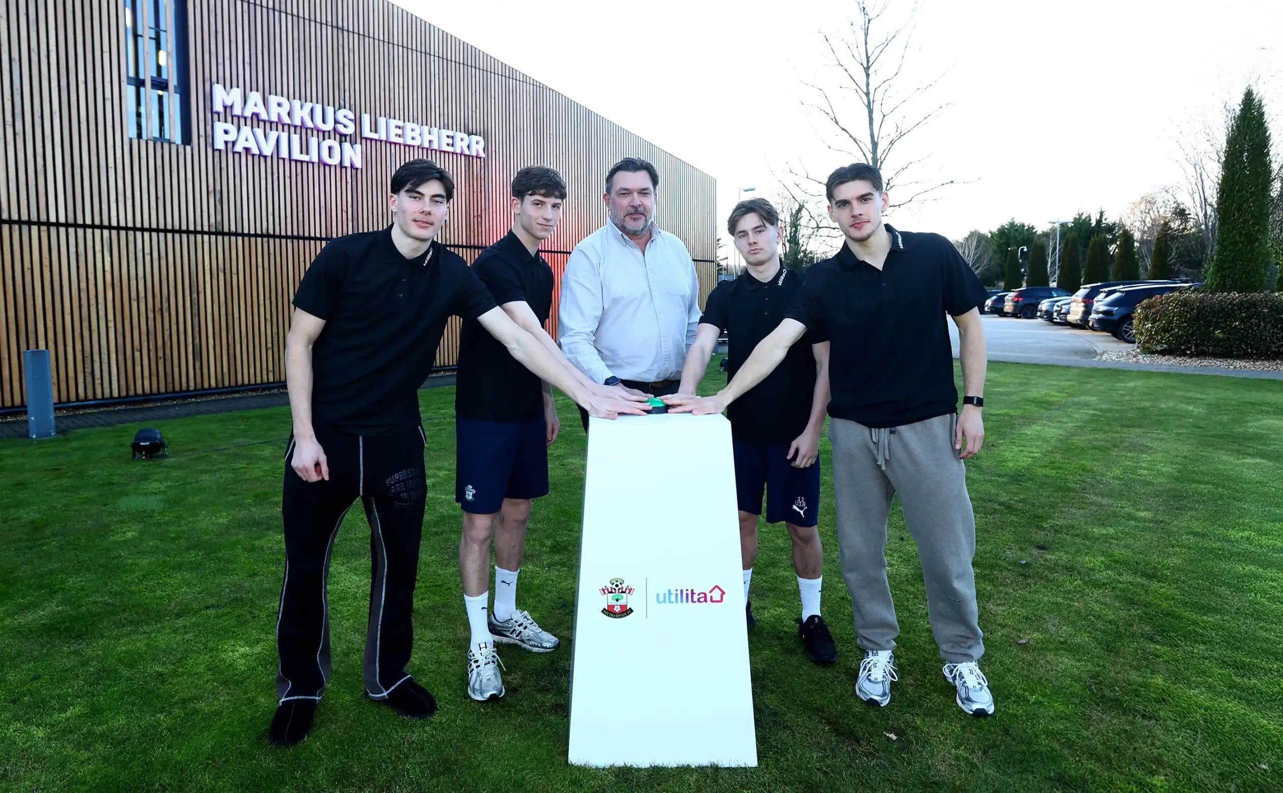 Bill Bullen standing with 2 Southampton Men's First Team players & 2 under 18 academy players outside the Staplewood Campus.